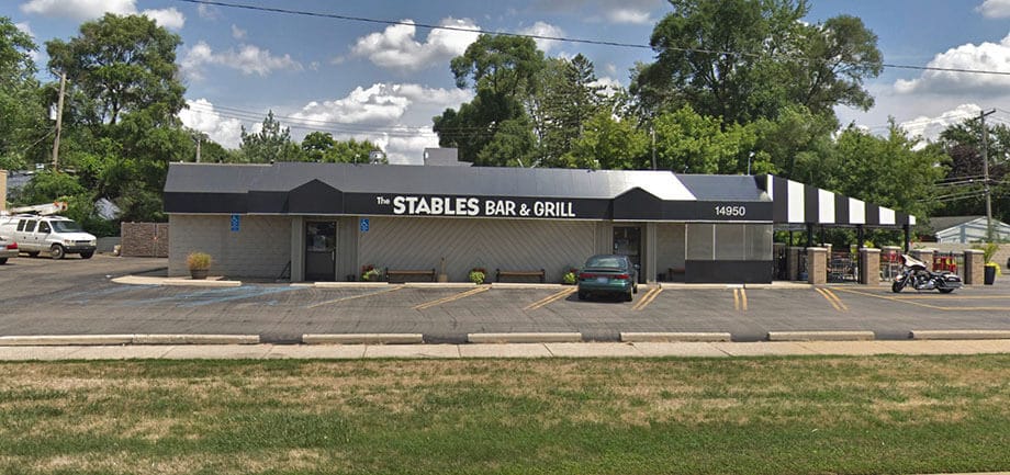 Custom commercial awnings - storefront awning with outdoor seating awning - The Stables Bar & Grill - Marygrove Awnings